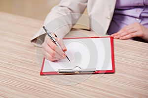 The hands taking notes in the pad