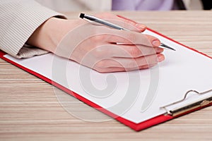 The hands taking notes in the pad