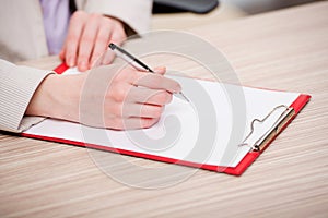 The hands taking notes in the pad