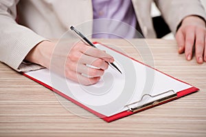 The hands taking notes in the pad