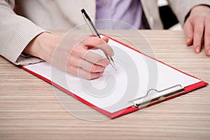 The hands taking notes in the pad