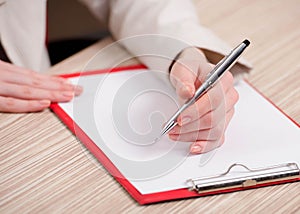 Hands taking notes in the pad