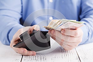 Hands taking out money from wallet
