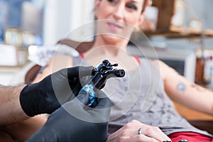 Hands of tattoo artist wearing sterile gloves