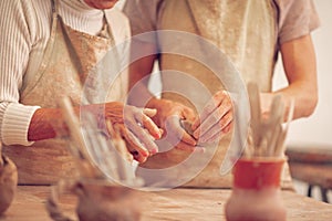 Hands of a teacher and her apprentice