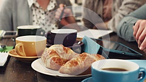 Hands, teamwork and business people planning at breakfast for collaboration, writing or morning strategy. Food