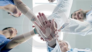 Hands, teamwork or doctors in huddle with support in collaboration for healthcare goals together. Hospital closeup