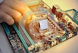 Hands of a technician assembling computer hardware parts.
