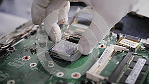 Hands of the technician repairing a computer, Technician who changes the computer`s processor, Close up with selective