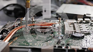 Hands of the technician repairing a computer, Technician who changes the computer`s processor, Close up with selective