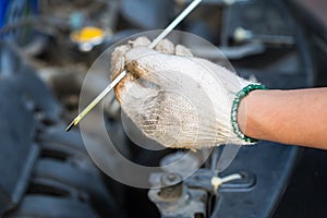 Hands of technicians Check Car Engine Oil , selective focus