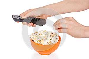 Hands a teenager with popcorn and remote control