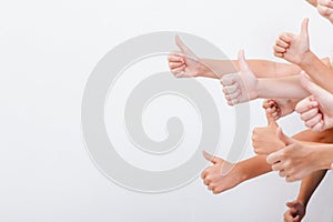 Hands of teenagers showing okay sign on white