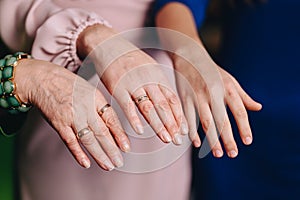 Hands of three generations with rings. Hands of mom daughter