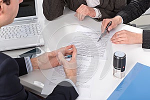 Hands of three people, signing documents