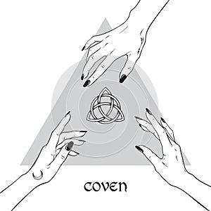 Hands of three witches reaching out to the pagan symbol triquetra. Coven is a gathering of witches. photo