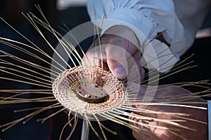 Hands of tinker making a product from wire