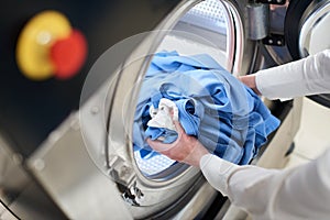 Hands to load the Laundry in the washing machine