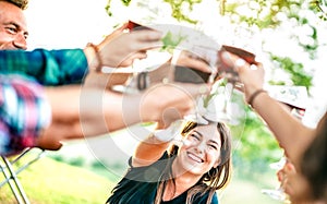 Hands toast with red wine - People having fun cheering at pic nic winetasting - Young friends enjoying harvest time together photo