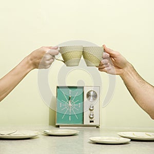 Hands toasting cups.