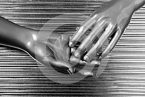 Hands together futuristic robot silver steel