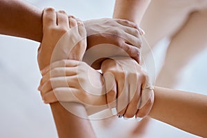 Hands, together and solidarity with a group of people strong in unity from above for teamwork or collaboration. Trust