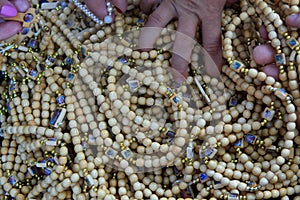 Hands touching bunch of rosaries