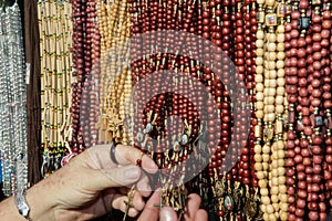 Hands touching bunch of rosaries