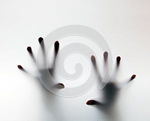 Hands touching frosted glass. Conceptual scream for help photo