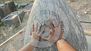 Hands touching Sacred Omphalos Stone