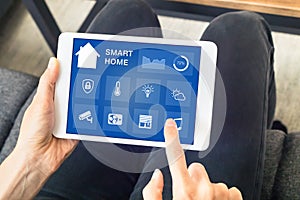 Hands touching smart home automation assistant screen on tablet, interior