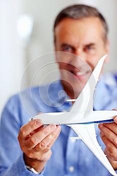 Hands, travel and model airplane with a businessman in the office for a global or international trip. Corporate