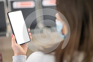 Hands traveler using smartphone mobile in the airport lounge. Blank screen cell phone with space for copy at the airport. woman