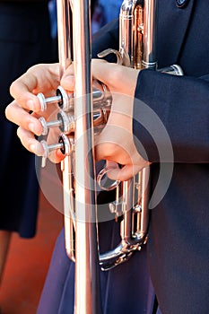 Hands on a trumpet close up.