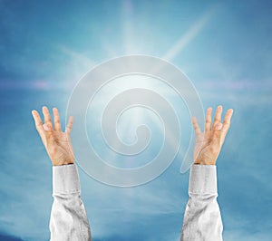 Hands trying to reach on the sky with sunshine rays