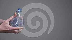 Hands twisting bottle crumpled plastic reduce concept. Crushed bottle water. Resize. Used pet. Grab hands crushed