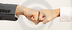 Hands of two business people wear making a fist pump together after good deal. success and show strength power