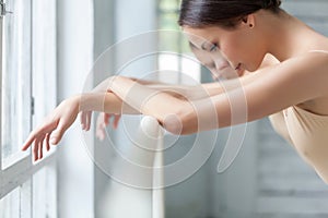 The hands of two classic ballet dancers at barre