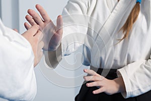 Hands of two girls practice Aikido on martial arts training