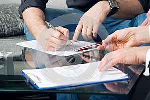 Two people signing a document photo