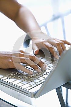 Hands typing on keyboard.