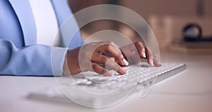 Hands, typing and keyboard with a business woman at work at her desk on a report or email in the office. Computer