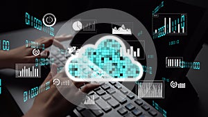 Hands Typing on Keyboard with Cloud Computing Graphics and Data Analytics Displayed on Computer Screen for Digital