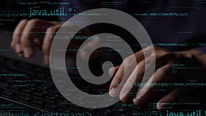 Hands typing on a keyboard with code in the background representing programming and software development concepts in a