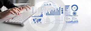 Hands typing on a keyboard with digital graphs, statistics, and analytics displayed on a light background representing