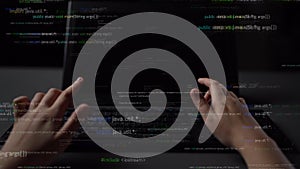 Hands Typing on a Laptop with Code Overlay in a Dark Environment Representing Programming, Technology, and Software