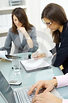 Hands typing on laptop computer