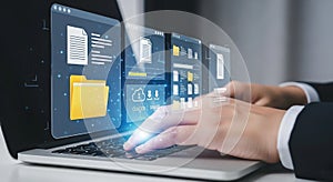 Hands typing on laptop with digital interface displaying files