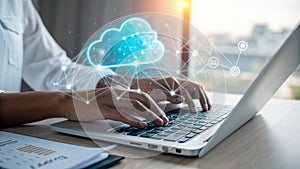 Hands typing on laptop with glowing cloud icon representing cloud computing and digital technology