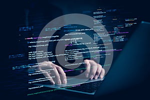 Hands typing on laptop with programming code on screen, representing software development. Perfect for coding, IT solutions,